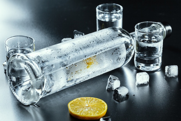 Cold vodka in shot glasses on a black background